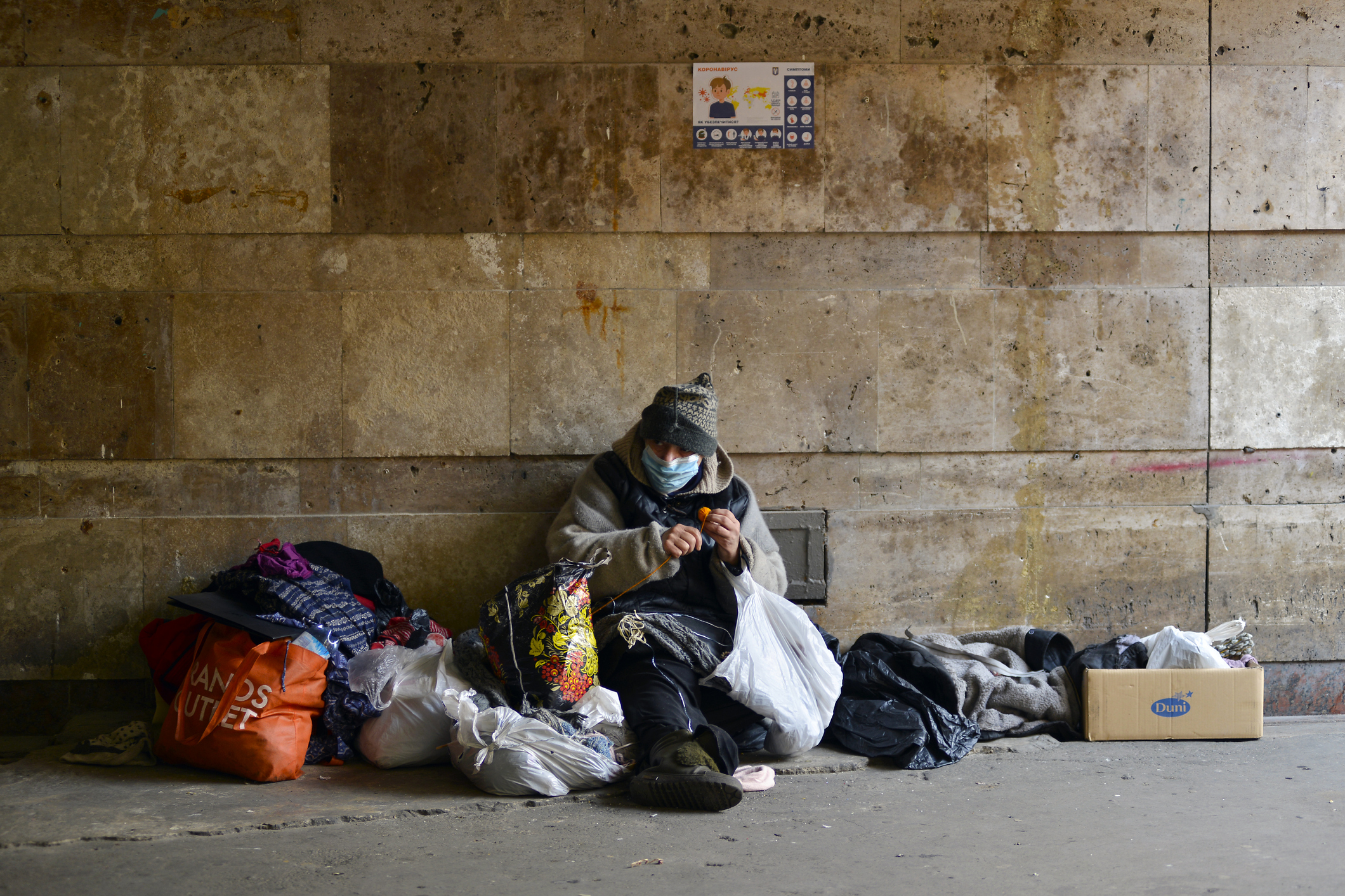 homeless woman in medical mask