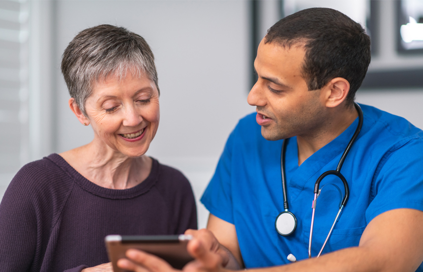 Male doctor consults female patient