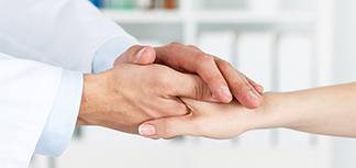 Doctor holding patient's hands