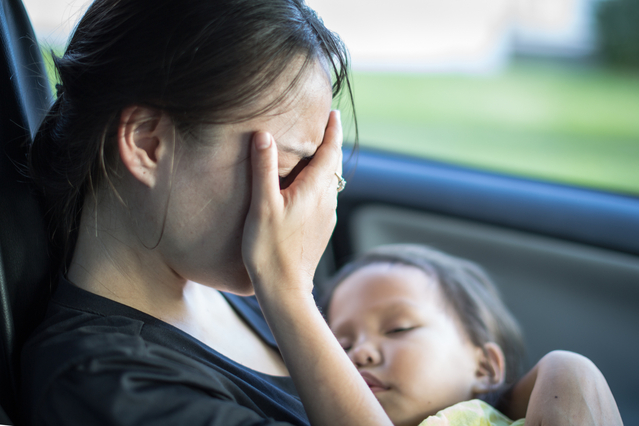 stressed tired mother holding her baby