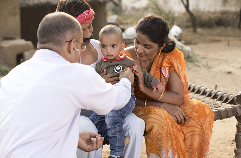 indian pediatrician with little boy 