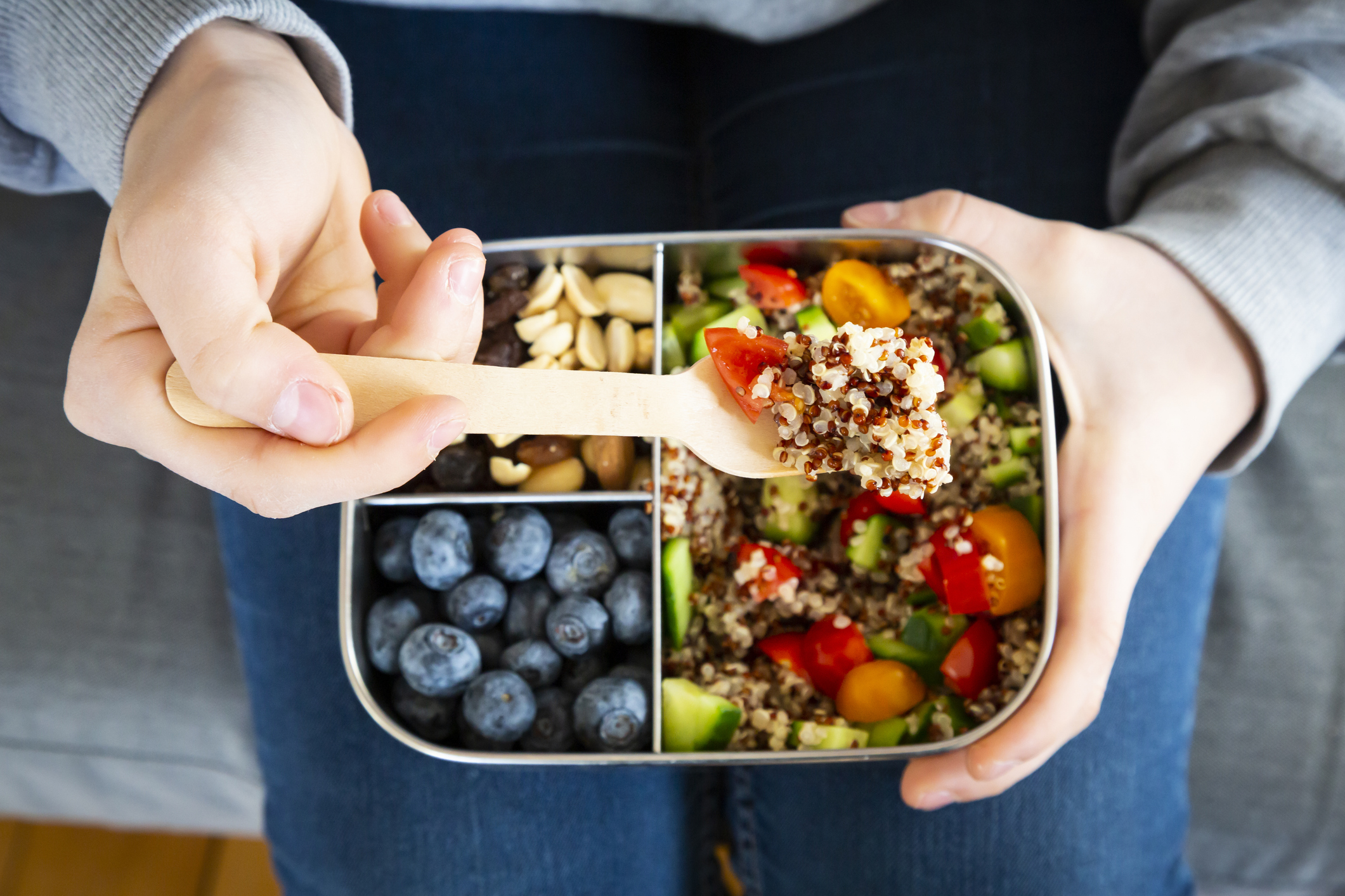 Lunchbox with quinoa salad with tomato and cucumber