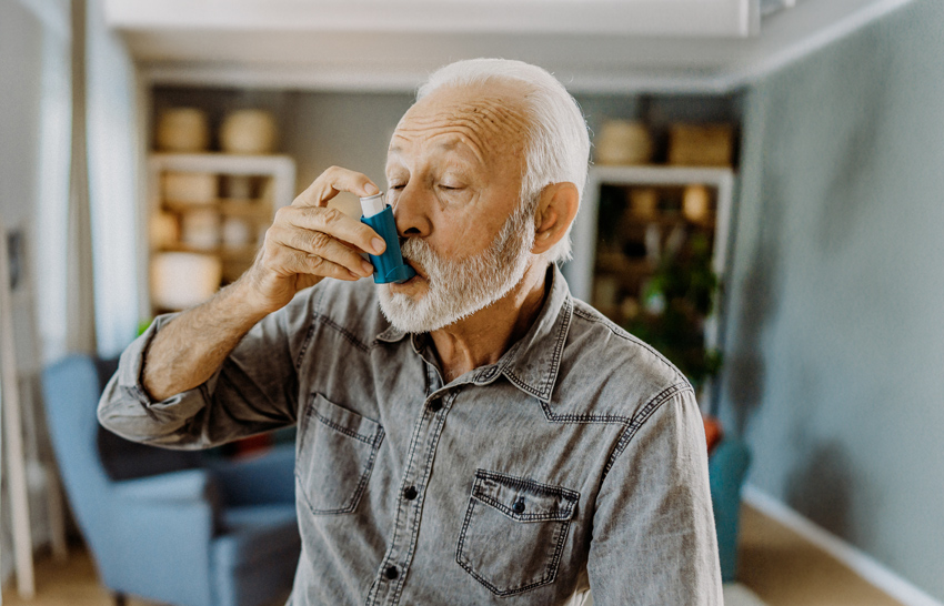 man using an inhaler