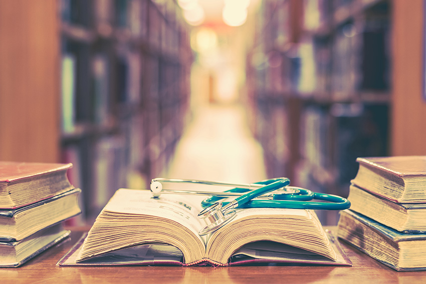 book with stethoscope on it in library