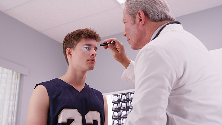 doctor looking at an athlete 