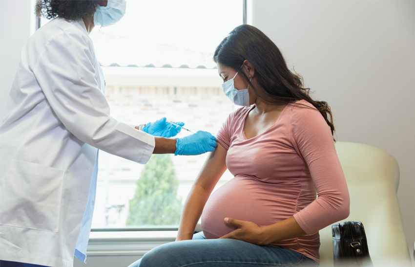 woman visiting her doctor obtaining a vaccine shot