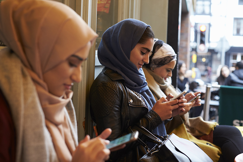 Muslim woman texting 