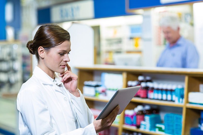 Pharmacist looking at tablet