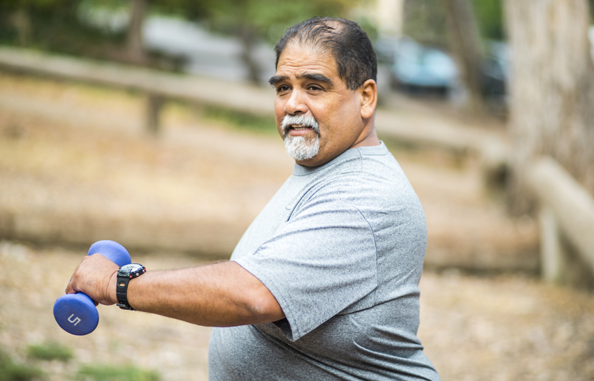 Senior man holding weights