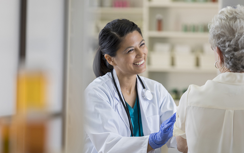 pharmacist smiling at patient 