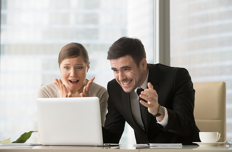 Surprised office people looking at laptop screen 