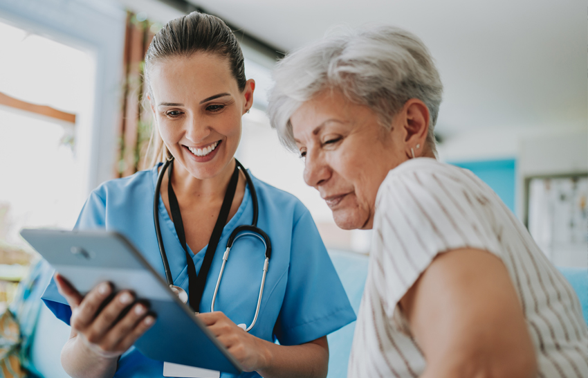 patient looking at tablet with their provider