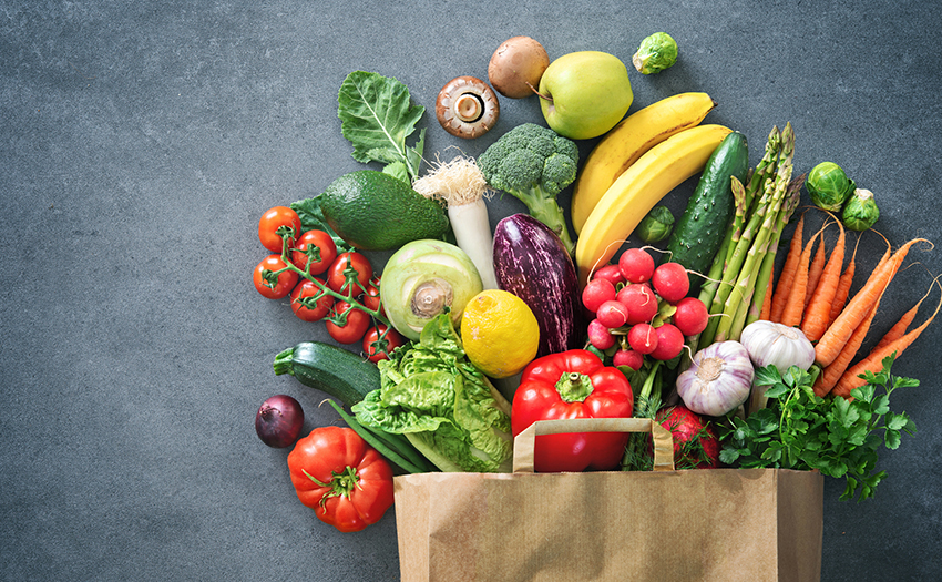 veggies sticking our of a paper bag