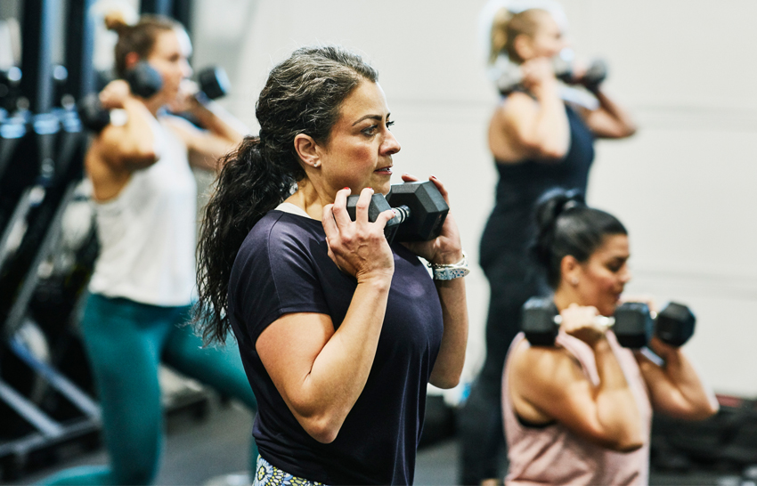 woman doing dumbell squats