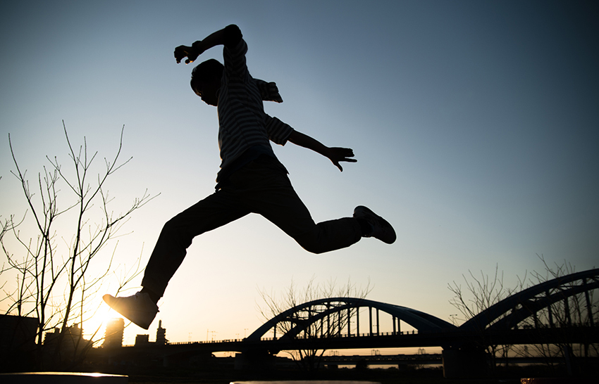 silhouette of young man jumping