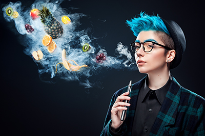 person with blue hair blowing fruit smoking from vape