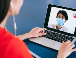 Woman meeting with her doctor via her computer 
