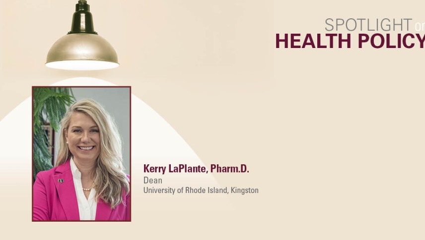 Woman in pink blazer underneath light