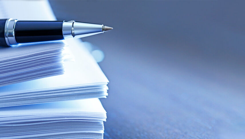 pen-on-stack-of-papers