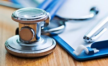 Stethoscope with writing pad and pen