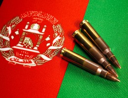 Three rifle cartridges on the flag of Afghanistan.