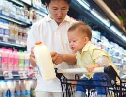 Asian Father & Cute little 18 months old toddler boy child choosing milk product in grocery store.