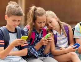 children looking at cell phone