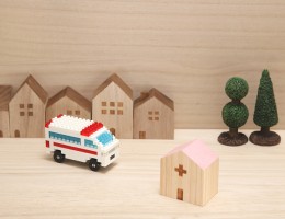 Lego ambulance near houses