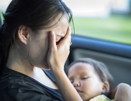 stressed tired mother holding her baby