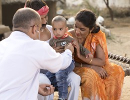 indian pediatrician with little boy 