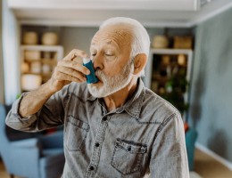 man using an inhaler