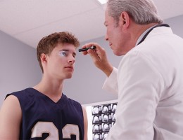 doctor looking at an athlete 