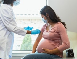 woman visiting her doctor obtaining a vaccine shot