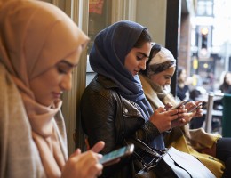 Muslim woman texting 