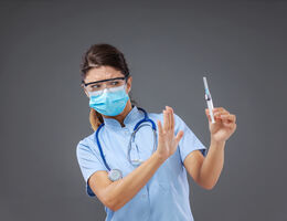 Nurse holding a needle