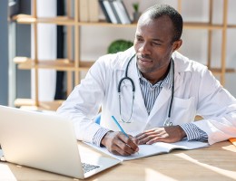 physician learning on a laptop 