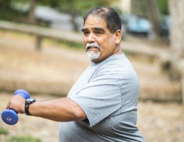 Senior man holding weights
