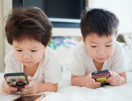 two young children on cell phones