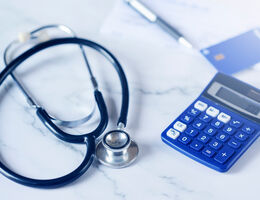 Blue credit card next to stenoscope and calculator