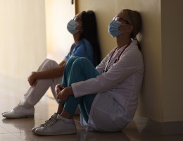 tired medical staff leaning on wall