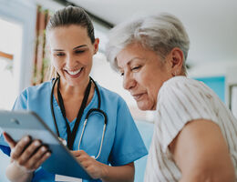 patient looking at tablet with their provider