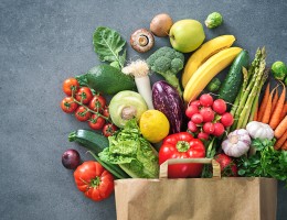 veggies sticking our of a paper bag