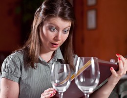 Woman looking at menu- surprised by calorie count